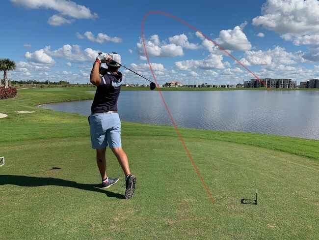 Golfer Hitting A Slice Into The Water Golfer Hitting A Slice Into The Water